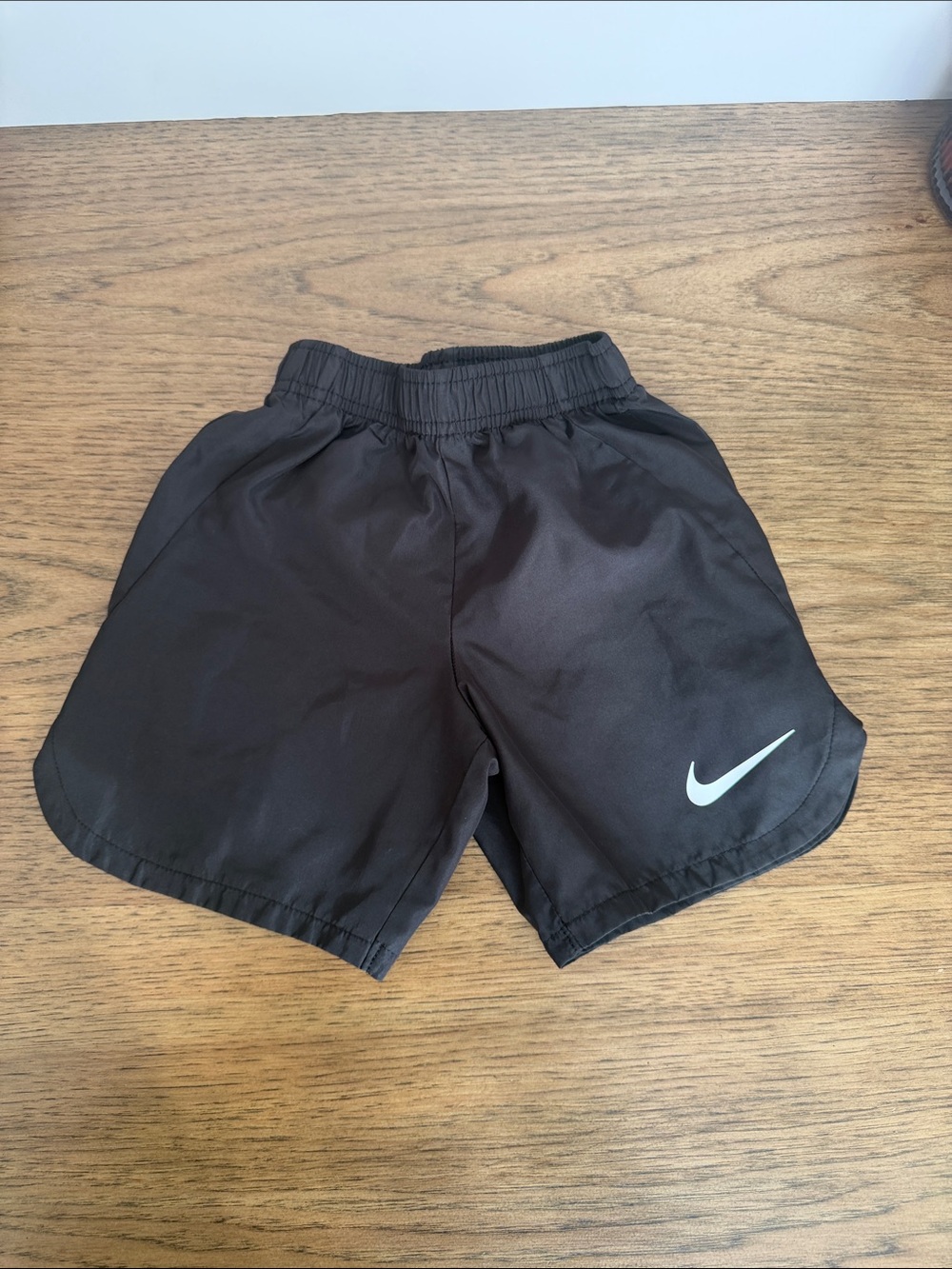 Nike Kids Black Athletic Shorts with White Swoosh